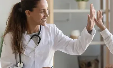 Family Nurse Practitioner FNP High Fiving Child Patient