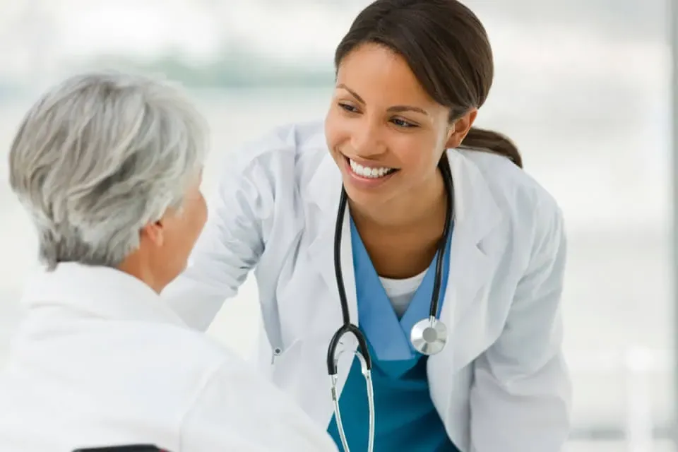 FNP Smiling at Geriatric Patient in Wheelchair