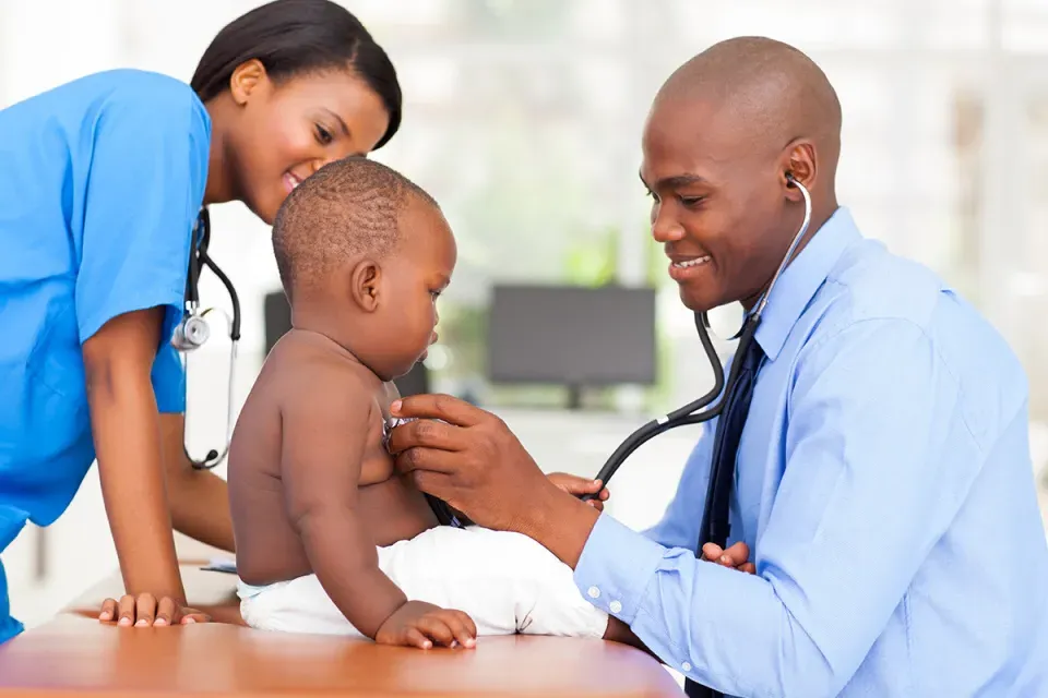 Family Nurse Practitioner Taking Heart Rate of Pediatric Patient